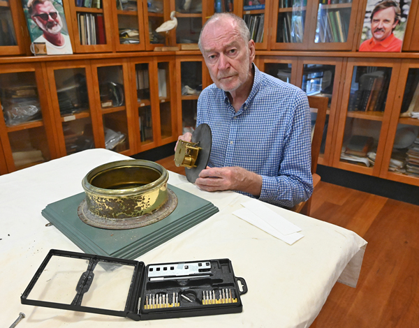 Martin Foster cleaning the Department of Civil Aviation clock in the Museum library